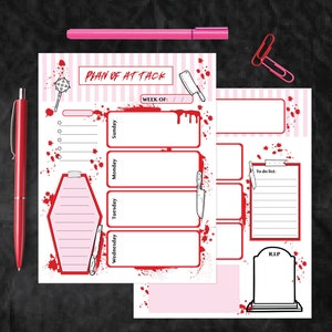 May include: A pink and white planner with a bloody theme. The planner has a section for each day of the week, a to-do list, and a RIP section. The planner has a title that says "Plan of Attack".