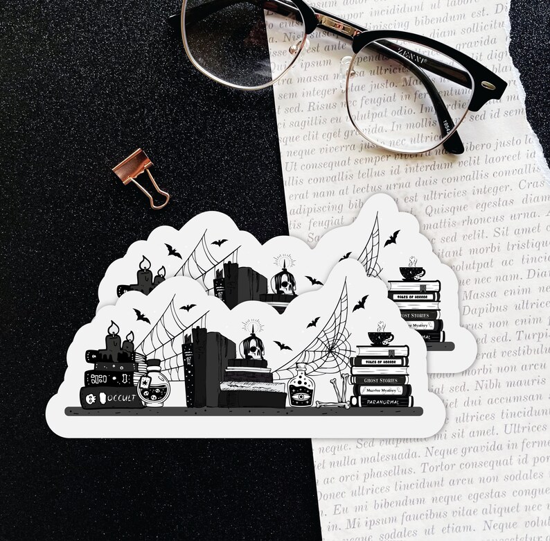 May include: Two black and white stickers featuring a stack of books with a skull, candles, and spiderwebs. The text on the stickers reads "Ghost Stories" and "Occult".