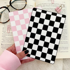 May include: A pink and white checkerboard pattern and a black and white checkerboard pattern. Both are printed on cardstock and are used as a visual aid for planning and organizing.