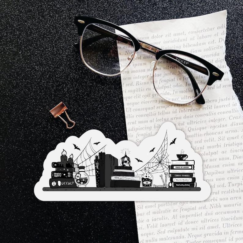 May include: A black and white illustration of a bookshelf with books, candles, and potion bottles. The books have titles like "Ghost Stories" and "Paranormal". There are cobwebs and bats in the background.