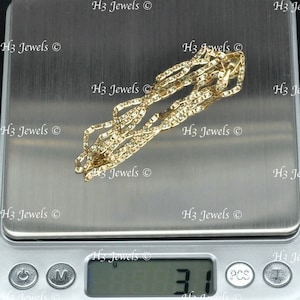 May include: A gold chain necklace on a digital scale, the scale reads 3.1 grams.