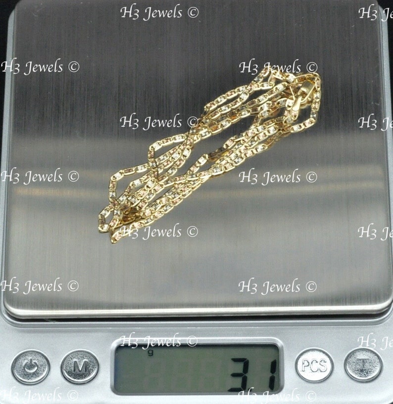May include: A gold chain necklace on a digital scale, the scale reads 3.1 grams.