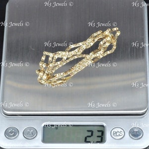 May include: A gold chain necklace on a digital scale, the scale reads 2.3 grams. The chain is on a white surface with the text "H3 Jewels" repeated multiple times.