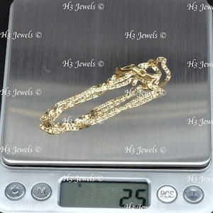 May include: A gold chain necklace on a digital scale, the scale reads 25 grams.