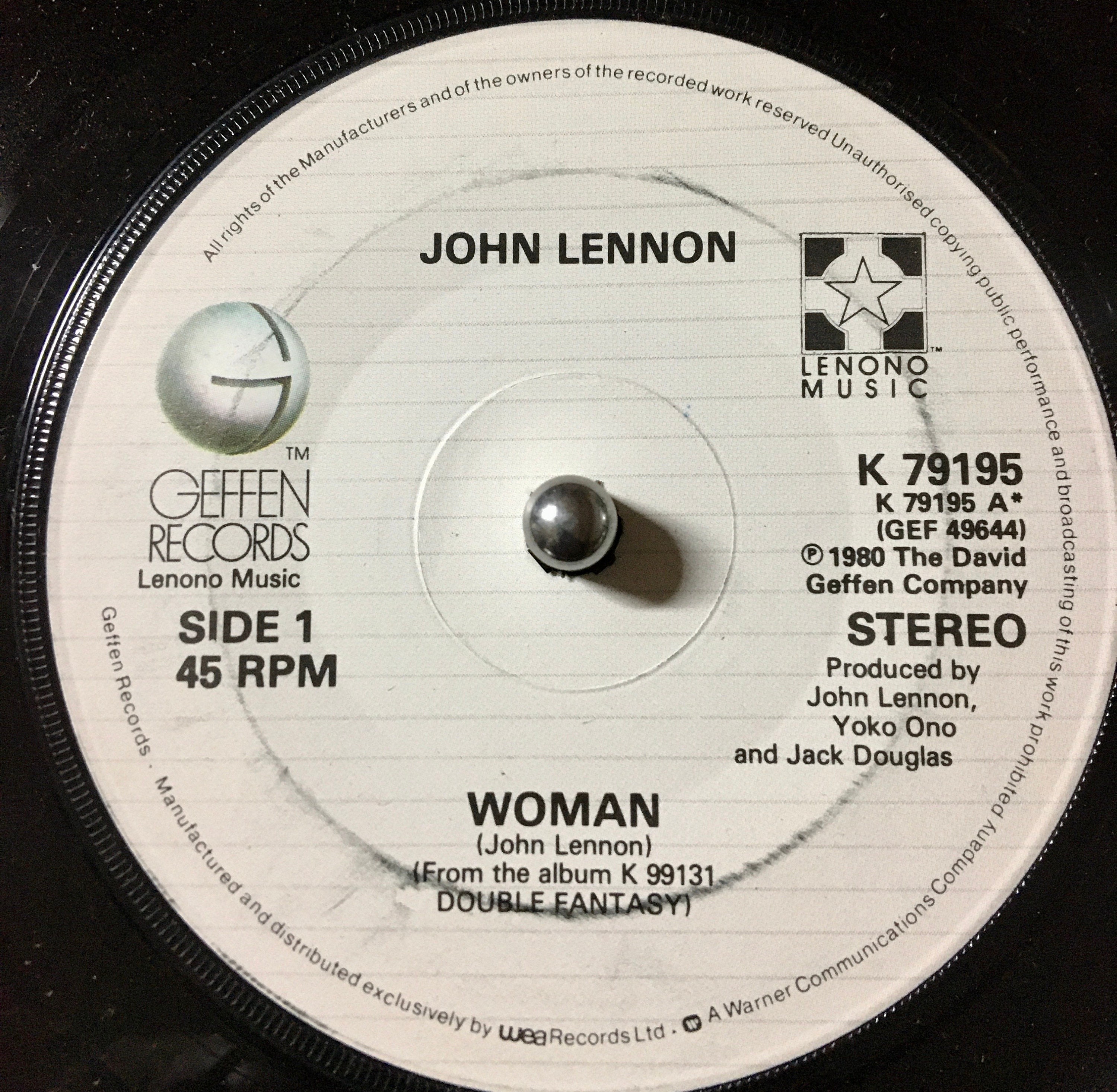 Cover and 45 Rpm of the Single WOMAN by John Lennon from 1981. he