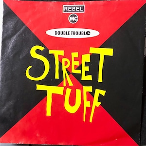 May include: A black and red record cover with the text "Rebel MC Double Trouble Street Tuff" in yellow lettering.