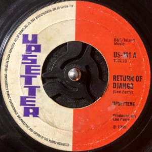 May include: A black and white 45 RPM vinyl record with a red and white label. The label has the text "B&C/Island Music", "US-301 A", "TMX.73", "Return of Django (Lee Perry)", "Upsetters", "Produced by: Lee Perry", and "℗ 1369".