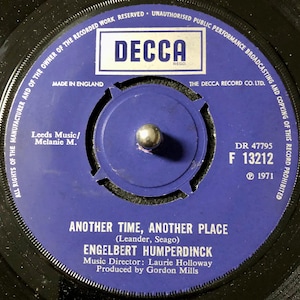 May include: A blue vinyl record with the title "Another Time, Another Place" by Engelbert Humperdinck. The record label is purple with the Decca logo and the song information. The record number is DR 47795 F 13212. The copyright is 1971.