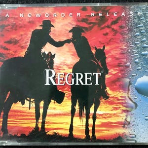 Puede incluir: Un single de CD de New Order con un fondo de puesta de sol y dos vaqueros a caballo. El título de la canción es "Regret".