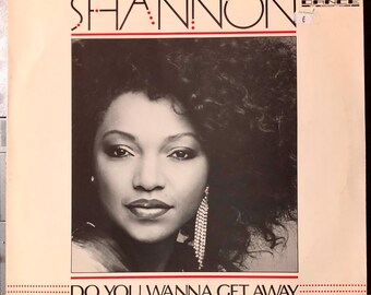Op de afbeelding: Vintage vinyl albumhoes met de artiest Shannon. De albumhoes is overwegend zwart-wit, met een portret van Shannon. De albumtitel "DO YOU WANNA GET AWAY" staat onderaan.