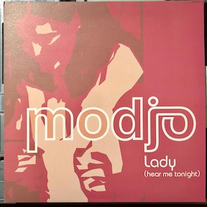 Peut inclure: Une pochette d'album carrée aux tons rose et pêche. Le mot "modjo" est en grandes lettres blanches, avec le mot "Lady" en dessous. Le texte "(hear me tonight)" est en dessous de "Lady". Une image stylisée d'une personne est en arrière-plan.