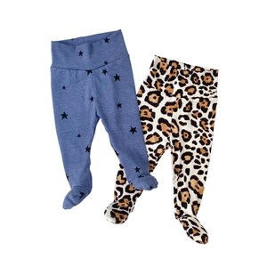 May include: Two pairs of baby leggings. One pair is blue with black stars and the other pair is brown and white with a leopard print.