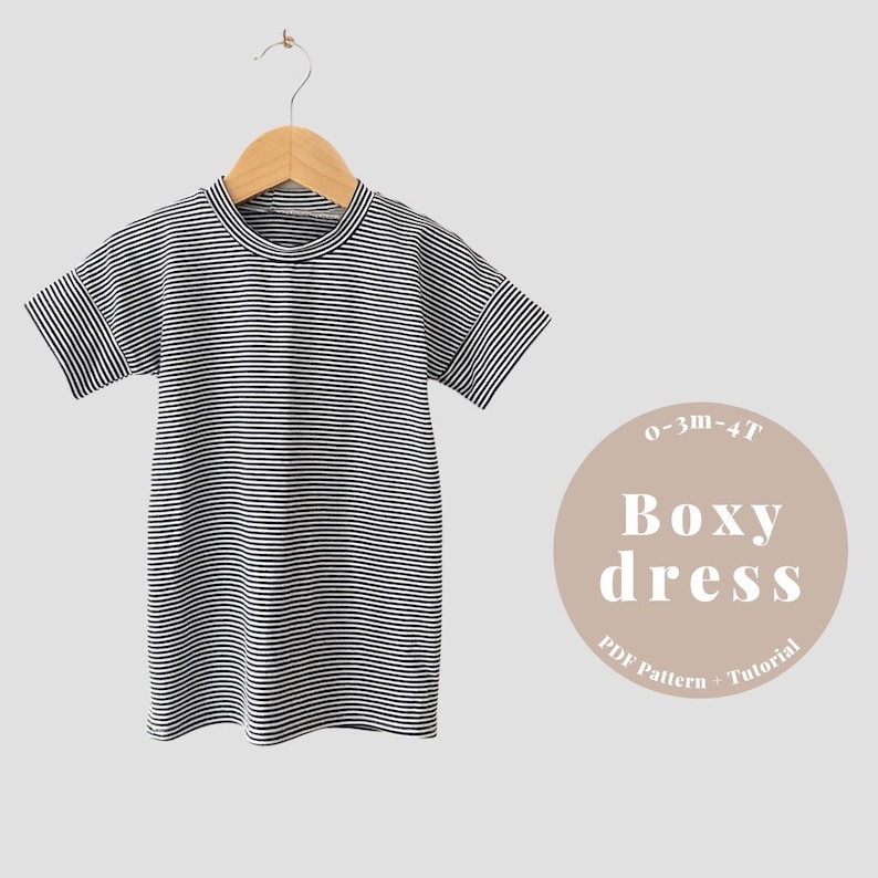 May include: A black and white striped boxy dress for babies and toddlers, sizes 0-3 months to 4T. The dress is hanging on a wooden hanger. The text "0-3m-4T Boxy dress PDF Pattern + Tutorial" is on a brown circle.