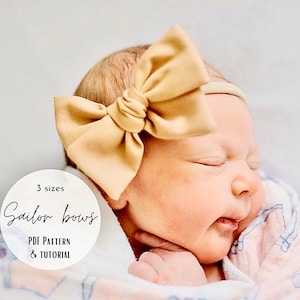 May include: A baby wearing a light brown sailor bow headband. The headband is made of fabric and has a knotted center. The text "3 sizes Sailor bows PDF PATTERN & TUTORIAL" is on a white circle.