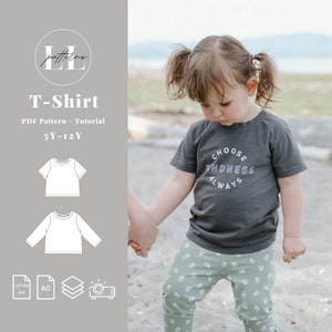 May include: A PDF pattern and tutorial for a T-shirt for children aged 5 to 12. The pattern includes instructions for both short and long sleeve versions. The image shows a child wearing a grey T-shirt with the text "CHOOSE KINDNESS ALWAYS" printed on it.