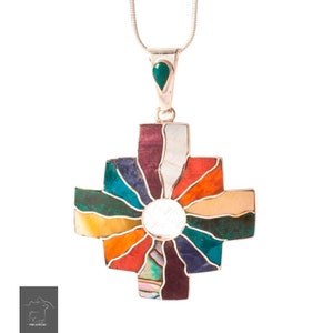 May include: A silver necklace with a colorful cross pendant. The cross is made of various stones, including turquoise, red, orange, yellow, green, and purple. The pendant is attached to a silver chain.