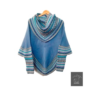 May include: A blue knitted poncho with a geometric pattern in shades of blue, purple, and white. The poncho has a high neck and a wide, loose fit.