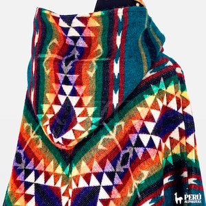 May include: A colorful hooded alpaca wool poncho with a geometric pattern in shades of red, orange, yellow, green, blue, and white.
