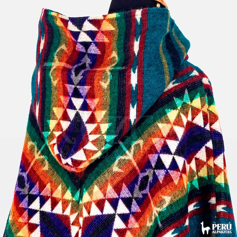 May include: A colorful hooded alpaca wool poncho with a geometric pattern in shades of red, orange, yellow, green, blue, and white.