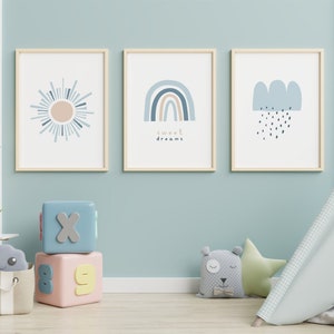 May include: Three framed art prints with a sun, rainbow, and cloud design in a child's room. The rainbow print has the words "sweet dreams". The room also has a play tent, blocks, and stuffed animals.