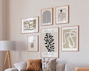 May include: A living room interior with a light grey sofa and a light grey armchair. The sofa has a brown throw pillow and a vase with dried flowers. There are six framed prints on the wall behind the sofa. The prints are in a minimalist style with black and white lines and shapes. The text on the prints reads "Botanical Forms of Art".