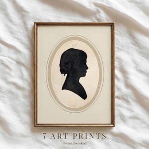 May include: A framed art print featuring a black silhouette of a woman's profile within an oval frame. The print is set against a beige background, with the text "7 ART PRINTS" and "Instant Download" at the bottom. The frame is a warm brown.