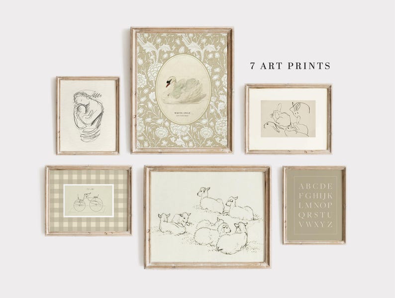 May include: Set of seven art prints in neutral colors with a variety of designs, including a swan, a bicycle, a rabbit, a group of lambs, and an alphabet. The prints are framed in light wood frames and arranged on a white wall.