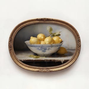 May include: An oval framed painting depicts a still life of lemons in a blue and white bowl. The bowl is filled with ripe yellow lemons and sits on a table. A few lemons are scattered around the bowl.