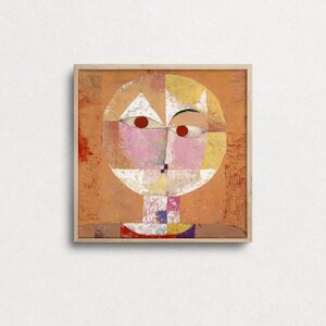 May include: Abstract painting of a face with geometric shapes in shades of pink, yellow, white, and orange. The face is surrounded by a circle and set against a background of orange.