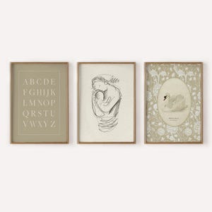 May include: Three framed prints with a minimalist aesthetic. The left print features the alphabet in a simple font on a light green background. The center print is a black and white line drawing of a mother holding a baby. The right print features a white swan on a floral background with the text "White Swan" in a serif font.