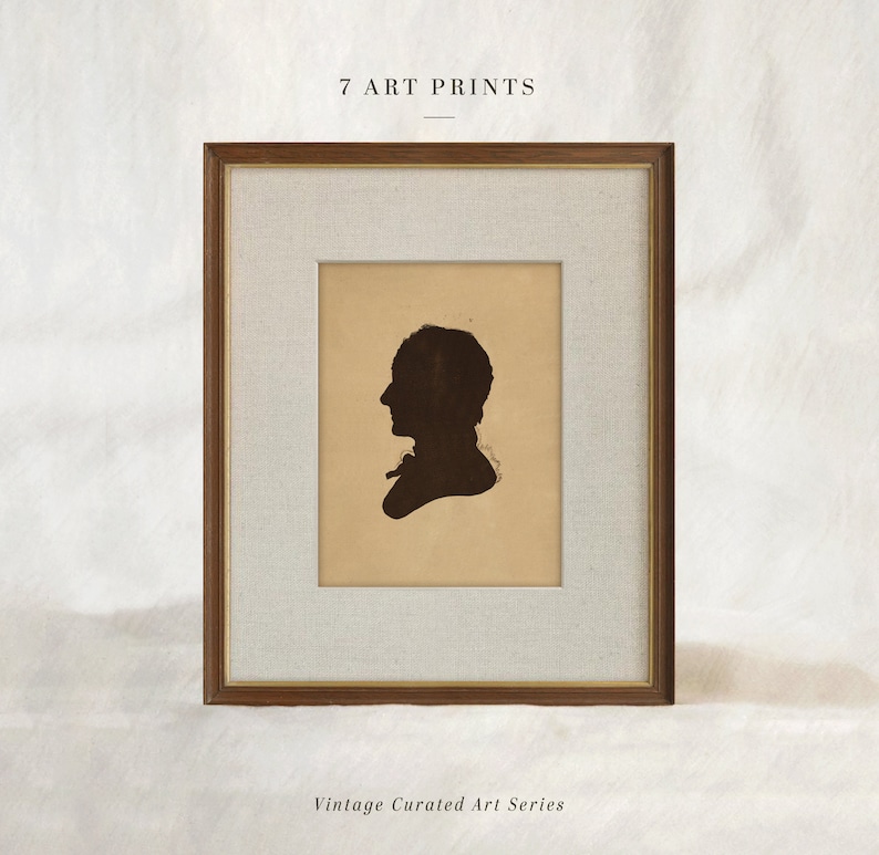 May include: A framed art print featuring a dark silhouette of a person in profile. The print is set against a tan background with a white mat and a brown wooden frame. The text "7 ART PRINTS" and "Vintage Curated Art Series" are visible.
