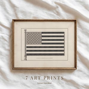 May include: Framed art print featuring a vintage illustration of the American flag. The flag is depicted in black and white with stars and stripes, mounted on a cream-colored background. The print is in a gold-toned frame. Text at the bottom reads "7 ART PRINTS" and "Instant Download."