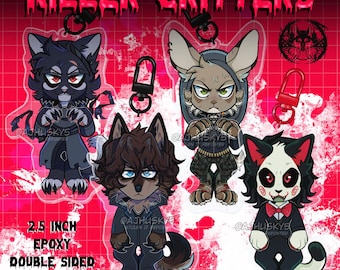Puede incluir: Cuatro charms de epoxi de doble cara de 2,5 pulgadas con personajes de dibujos animados de animales con un tema de terror. Los personajes son un gato negro, un lobo, un conejo y un gato con pajarita. Los charms están unidos a llaveros.
