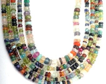 May include: A strand of colorful gemstone beads, including green, blue, red, orange, and yellow beads. The beads are faceted and have a variety of shapes and sizes.