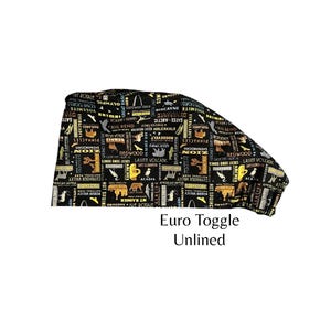May include: Black and tan Euro Toggle Unlined fabric with a repeating pattern of national park names and illustrations. The text "Euro Toggle Unlined" is printed in black below the fabric.