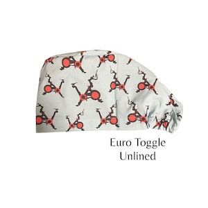 May include: A light blue scrub hat with a repeating pattern of red and black stationary bikes. The hat has a toggle closure and is unlined. The text "Euro Toggle Unlined" is printed below the hat.