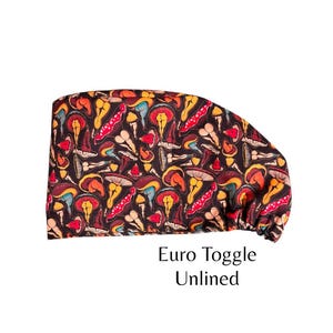 May include: A black scrub cap with a colorful mushroom print. The cap has a toggle closure and is unlined.