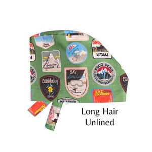 May include: Green surgical scrub cap with ski resort patches. Patches include "Sun Valley Idaho", "Ski Lake Tahoe", and "Pico Peak Rutland-Vermont". The cap is designed for long hair and is unlined.