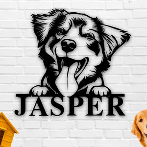 May include: Black and white silhouette of a dog with the name "Jasper" written below. The dog is looking to the right and has its tongue sticking out.