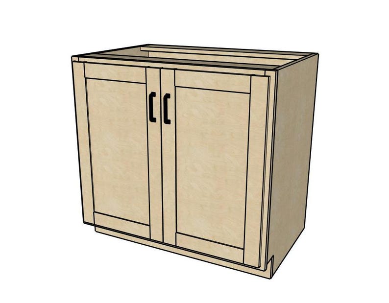 Pu&ograve; includere: Un mobile da cucina in legno chiaro con due ante e maniglie nere. L'armadio &egrave; grezzo e pronto per essere dipinto o tinto.