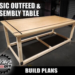 May include: A basic outfeed and assembly table made of wood with a plywood top. The table has a simple design with a rectangular frame and a single shelf. The table is shown in a workshop setting.