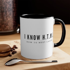 May include: White coffee mug with a black rim and handle. The mug has black text that reads "I KNOW H.T.M.L. HOW TO MEET LADIES".