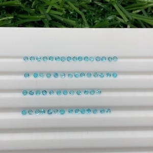 Amazing unheated brazilian paraiba faceted gemstone good color 61 pieces round shape 0.80 carat 1.4x1.4 mm height 0.9 mm