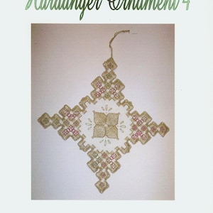 May include: A white background with a gold and green Hardanger ornament. The ornament is in the shape of a cross with a smaller cross in the center. The text "Hardanger Ornament 4" is at the top of the image and "Designed by April Morgan-Salo" is at the bottom.