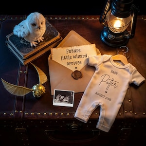 May include: A themed baby announcement with a white owl, a golden snitch, and a baby onesie that reads "Baby Potter August 2026." An open envelope with the text "Future little wizard arrives" is also present.