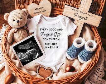 May include: A wicker basket filled with baby items, including a white onesie with the text "Every good and perfect gift comes from the Lord James 1:17", a teddy bear, a pair of blue booties, a wooden cross with the text "For this child we have prayed", and a heart-shaped wooden sign with the text "Arriving March 2024".