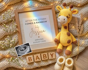 May include: A framed announcement with the text "After the storm comes a rainbow baby Jessica arriving August 2025".  The frame is on a knitted blanket with a crocheted giraffe toy, wooden blocks spelling "BABY", and a pair of crocheted booties.