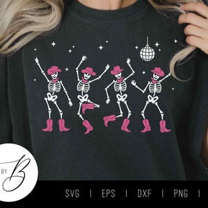 May include: Dark gray t-shirt featuring a graphic of four dancing skeletons wearing pink cowboy hats and boots. A disco ball and stars are above the skeletons. The shirt has the text "SVG BY B" in a circle at the bottom.