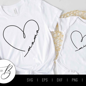 May include: Two white shirts with black heart designs. The larger shirt says "mama" inside the heart and the smaller shirt says "mini" inside the heart.