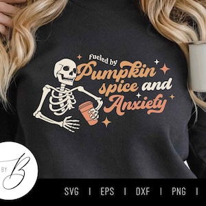 May include: Black sweatshirt with a skeleton holding a cup of coffee and the text "Fueled by Pumpkin Spice and Anxiety".